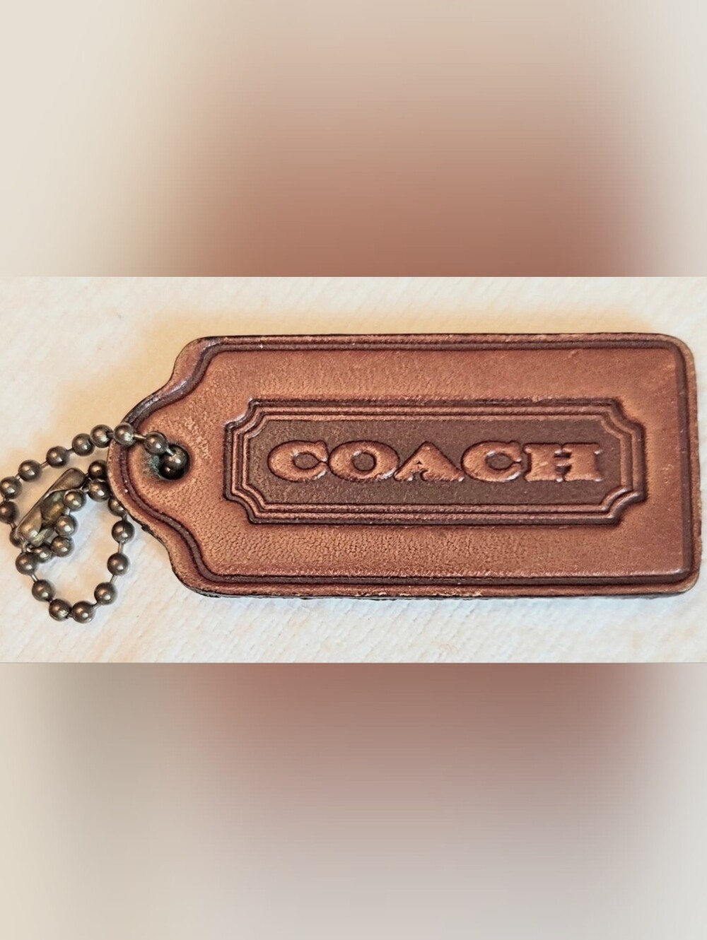 COACH Two sided embossed brown embosed hang tag key fob